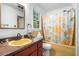Vintage bathroom with a yellow tub, shower curtain, and yellow countertops at 5317 Highway 81, Loganville, GA 30052