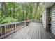 Wooden deck with gray railings, overlooking a green, wooded backyard at 5317 Highway 81, Loganville, GA 30052