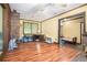 Spacious living room with hardwood floors, a brick accent wall, and an open layout perfect for entertaining guests at 5317 Highway 81, Loganville, GA 30052