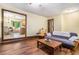 Bright living room with hardwood floors, comfortable seating, and a view into the dining area and kitchen at 5317 Highway 81, Loganville, GA 30052