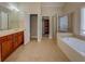 Large bathroom with double sink vanity, glass shower, and walk-in closet at 1065 Chippewa Oak Dr, Dacula, GA 30019