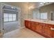 Bathroom showing the vanity, large mirror, and doorway to the main bedroom at 1065 Chippewa Oak Dr, Dacula, GA 30019