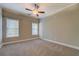 Spacious bedroom with neutral walls, carpet, ceiling fan and two windows at 1065 Chippewa Oak Dr, Dacula, GA 30019