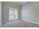 Neutral bedroom with large window and carpeting, ready for personalization at 1065 Chippewa Oak Dr, Dacula, GA 30019