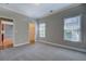 Cozy bedroom with two windows, and a view into the hall at 1065 Chippewa Oak Dr, Dacula, GA 30019