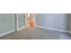 Neutral bedroom with French doors, carpet, and a glimpse of the living area at 1065 Chippewa Oak Dr, Dacula, GA 30019
