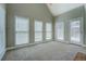 Cozy bonus room featuring three windows and a door leading to the backyard, offering versatile space and natural light at 1065 Chippewa Oak Dr, Dacula, GA 30019
