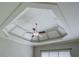 Close up of the coffered ceiling with fan and a window with blinds in the background at 1065 Chippewa Oak Dr, Dacula, GA 30019