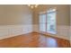 Dining Room featuring hardwood floors, wainscoting detail, and a view to the yard at 1065 Chippewa Oak Dr, Dacula, GA 30019