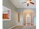 Bright entryway features an arched opening, chandelier, and neutral carpeting and paint at 1065 Chippewa Oak Dr, Dacula, GA 30019