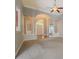 Bright entryway features an arched opening, chandelier, and neutral carpeting and paint at 1065 Chippewa Oak Dr, Dacula, GA 30019