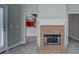 Close-up of a brick fireplace in a living room, seamlessly connecting to the adjacent kitchen and outdoor area at 1065 Chippewa Oak Dr, Dacula, GA 30019