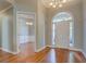 Bright foyer with gleaming hardwood floors, a chandelier, and a view into the adjacent dining room, creating an open entry at 1065 Chippewa Oak Dr, Dacula, GA 30019