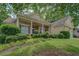 Charming home featuring a well-kept front yard, lush landscaping, and a welcoming entrance with pillars at 1065 Chippewa Oak Dr, Dacula, GA 30019
