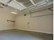 Clean, empty two-car garage with painted walls and floors, equipped with garage door openers at 1065 Chippewa Oak Dr, Dacula, GA 30019