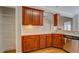 Kitchenette with stainless appliances, cherry cabinetry, light countertops, and pantry at 1065 Chippewa Oak Dr, Dacula, GA 30019