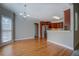 Kitchenette area features hardwood flooring, chandelier lighting, and views to a dining and living area at 1065 Chippewa Oak Dr, Dacula, GA 30019