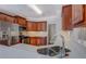 Kitchenette area features stainless appliances, light countertops, and cherry cabinetry at 1065 Chippewa Oak Dr, Dacula, GA 30019