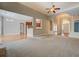 Open-concept living room flowing into the kitchen and foyer, highlighted by a fireplace and natural light, inviting and spacious at 1065 Chippewa Oak Dr, Dacula, GA 30019