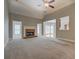 Bright living room with a fireplace, vaulted ceilings, and an open layout with natural light creating a cozy atmosphere at 1065 Chippewa Oak Dr, Dacula, GA 30019