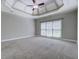 Large main bedroom with coffered ceiling, fan, neutral colors, and large windows at 1065 Chippewa Oak Dr, Dacula, GA 30019