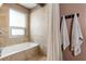 Serene bathroom with neutral tile, a tub, and soft lighting at 1661 La France Ne St # 222, Atlanta, GA 30307