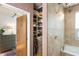 Bathroom leading to walk-in closet with custom shelving and ample storage at 1661 La France Ne St # 222, Atlanta, GA 30307