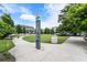 Outdoor community sign and grassy area with pedestrian walkway, in a walkable neighborhood at 1661 La France Ne St # 222, Atlanta, GA 30307