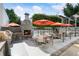 Outdoor dining area with stone fireplace and grilling stations, perfect for gatherings at 1661 La France Ne St # 222, Atlanta, GA 30307