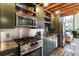 Modern kitchen features stainless appliances, sleek green cabinets, and granite countertops at 1661 La France Ne St # 222, Atlanta, GA 30307