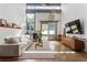 Sunny living room featuring high ceilings, a modern couch, and large windows at 1661 La France Ne St # 222, Atlanta, GA 30307