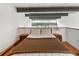 Inviting main bedroom with neutral tones, wood floors, and exposed beam architectural detail at 1661 La France Ne St # 222, Atlanta, GA 30307