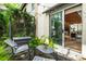 Inviting patio area with lush ferns and string lights, seamlessly connects to indoor living space at 1661 La France Ne St # 222, Atlanta, GA 30307