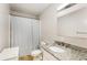 Standard bathroom features a granite countertop vanity, mirror, and shower with a curtain rod at 1841 Mobley St, Austell, GA 30106
