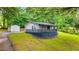 The property features a shed, nice lawn, and mature landscaping at 1841 Mobley St, Austell, GA 30106