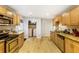 Well-lit kitchen featuring light cabinets, granite countertops, and laundry closet at 1841 Mobley St, Austell, GA 30106