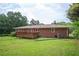 Brick house featuring a wooden deck with a large, well-maintained lawn at 3332 Clay Rd, Austell, GA 30106