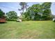 Expansive backyard with lush green grass and a storage shed offering plenty of space for outdoor activities at 3332 Clay Rd, Austell, GA 30106