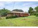 Expansive backyard featuring a brick home with a spacious wooden deck and mature trees at 3332 Clay Rd, Austell, GA 30106