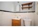 Bathroom featuring wall tiles, a mirrored medicine cabinet, shelves, and a commode at 3332 Clay Rd, Austell, GA 30106