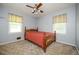 Bedroom featuring two windows, wood floors, and a traditional-style bed at 3332 Clay Rd, Austell, GA 30106