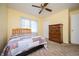 Comfortable bedroom with a ceiling fan, a window, and wooden furniture at 3332 Clay Rd, Austell, GA 30106