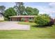 Traditional home with a well-maintained front yard, mature trees, and a curved driveway at 3332 Clay Rd, Austell, GA 30106