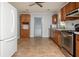 View of the kitchen shows white refrigerator, wood cabinets, and stainless appliances at 3332 Clay Rd, Austell, GA 30106