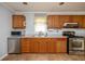Kitchen with stainless steel appliances, wood cabinets, and a view of the sink and window at 3332 Clay Rd, Austell, GA 30106