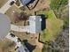 Aerial view of the home, yard, patio, and surrounding greenery at 7335 Treyland Ct, Cumming, GA 30041
