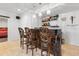 Basement bar with dark wood bar and decorative bar stools and back shelving at 7335 Treyland Ct, Cumming, GA 30041