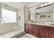 Bathroom with glass shower, double vessel sinks, granite counters, and modern fixtures at 7335 Treyland Ct, Cumming, GA 30041
