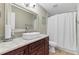 Bathroom featuring a vanity, white vessel sink, granite countertop, toilet, and shower with curtain at 7335 Treyland Ct, Cumming, GA 30041