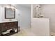 Updated bathroom with a large vanity, glass enclosed shower and neutral tile at 7335 Treyland Ct, Cumming, GA 30041